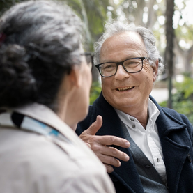 Older couple smile in conversation